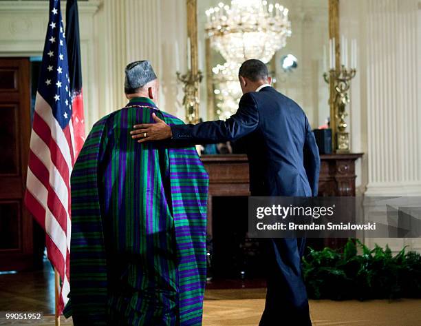 Afghanistan President Hamid Karzai and President Barack Obama leave after a joint press conference in the East Room of the White House May 12, 2010...