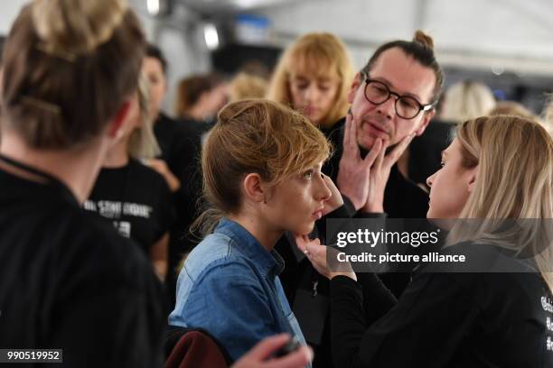 Dawid Tomaszewski prepares a model prior to the show during the Berlin Fashion Week at the E-Werk in Berlin, Germany, 15 January 2018. In the course...