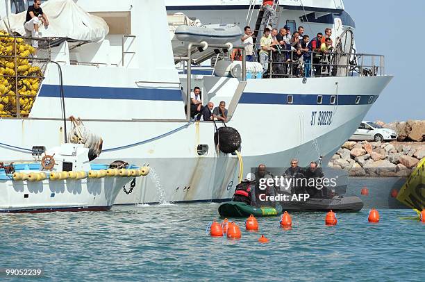 Policemen on a zodiac speaks with Greenpeace activists as they block Tuna fishing boats in the harbour of Frontignan, near Montpellier, southern...