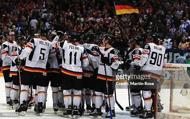 The team of Germany celebrate after the IIHF World Championship group A match between Denmark and Germany at Lanxess Arena on May 12, 2010 in...