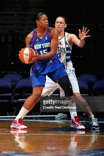 Kia Vaughn of the New York Liberty looks to pass around Kristen Mann of the Washington Mystics during the WNBA preseason game on May 5, 2010 at the...