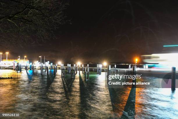 Ferry docks a the ferry port of Meersburg, Germany, 16 January 2018. The wind is forming high waves along the sea walls which shoot up for several...