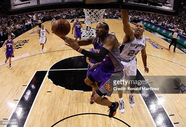 Guard Leandro Barbosa of the Phoenix Suns takes a shot against Richard Jefferson of the San Antonio Spurs in Game Four of the Western Conference...