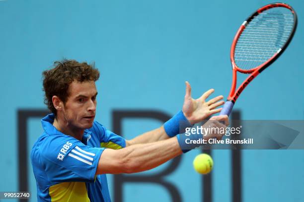 Andy Murray of Great Britain plays a backhand against Juan Ignacio Chela of Argentina in their second round match during the Mutua Madrilena Madrid...