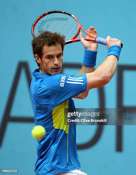 Andy Murray of Great Britain plays a backhand against Juan Ignacio Chela of Argentina in their second round match during the Mutua Madrilena Madrid...