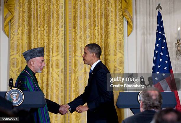 President Barack Obama, right, shakes hands with Hamid Karzai, Afghanistan's president, during a joint news conference in the East Room of the White...