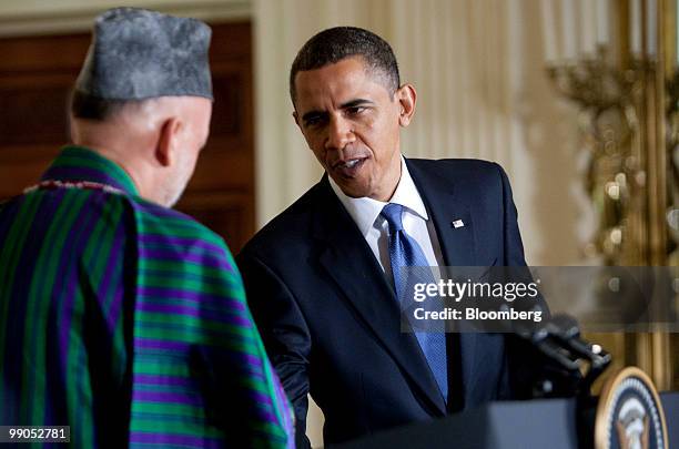 President Barack Obama, right, shakes hands with Hamid Karzai, Afghanistan's president, during a joint news conference in the East Room of the White...