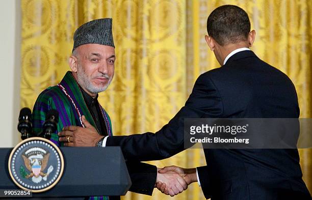 President Barack Obama, right, shakes hands with Hamid Karzai, Afghanistan's president, during a joint news conference in the East Room of the White...