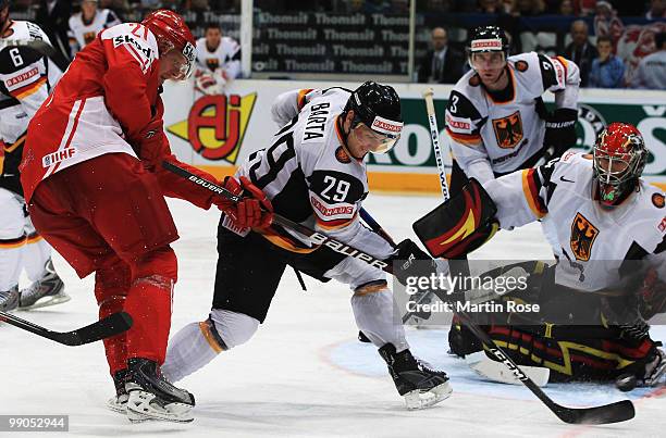 Thor Desler of Denmark and Alexander Barta of Germany battle for the puck during the IIHF World Championship group A match between Denmark and...