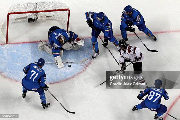 Aleksandrs Nizivijs of Latvia is surrounded by Luca Ansoldi, Michele Strazzabosco, Nicholas Plastino and Nicola Fontanive of Italy as he tries to...