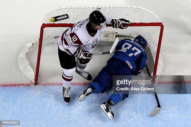 Nicola Fontanive of Italy lies in the goal next to Lauris Darzins of Latvia during the IIHF World Championship group C match between Italy and Latvia...