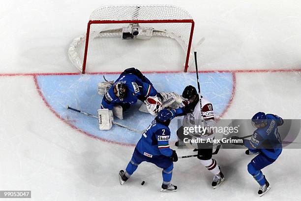 Lauris Darzins of Latvia tries to score against goalkeeper Adam Russo, Stefan Zisser and Trevor Johnson of Italy during the IIHF World Championship...