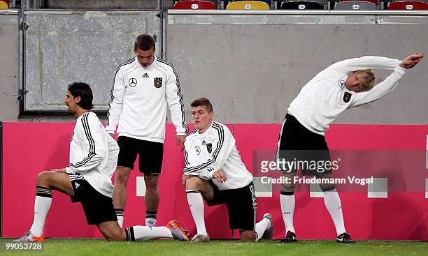 Sami Khedira, Lukas Podolski, Toni Kroos and Andreas Beck warm up during a German National team training session at the Esprit Arena on May 12, 2010...