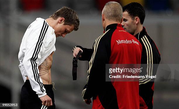 Marcell Jansen puts on a pulse measure during a German National team training session at the Esprit Arena on May 12, 2010 in Dusseldorf, Germany.