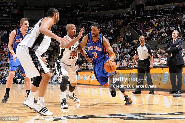 Tracy McGrady of the New York Knicks drives the ball against Keith Bogans of the San Antonio Spurs during the game on March 10, 2010 at the AT&T...