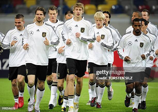 Germany's football players Lukas Podolski, Arne Friedrich, Marcell Jansen, Stefan Kiessling, Andreas Beck, Sami Khedira, Cacau and Dennis Aogo take...