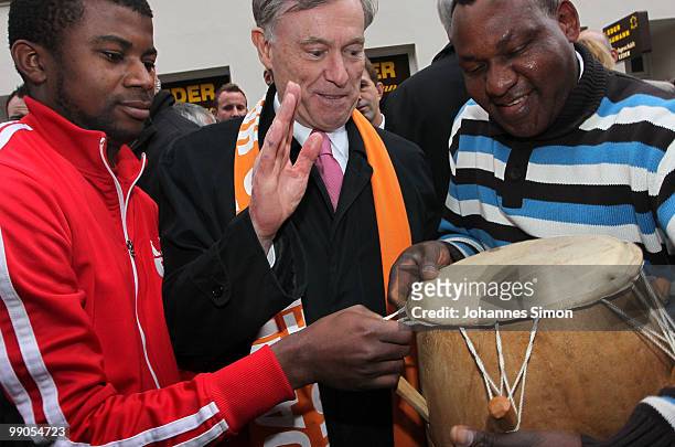 German President Horst Koehler beats the drum with African guests during day 1 of the 2nd Ecumenical Church Day at Marienplatz square on May 12, 2010...