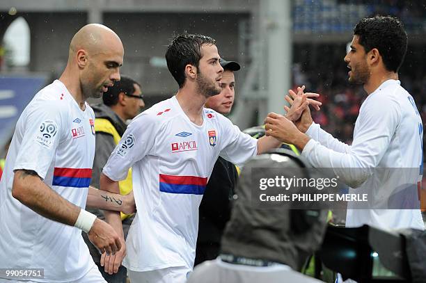Lyon's Bosnian midfielder Miralem Pjanic is congratulated by his teammates after scoring a goal during the French L1 football match Lyon versus...