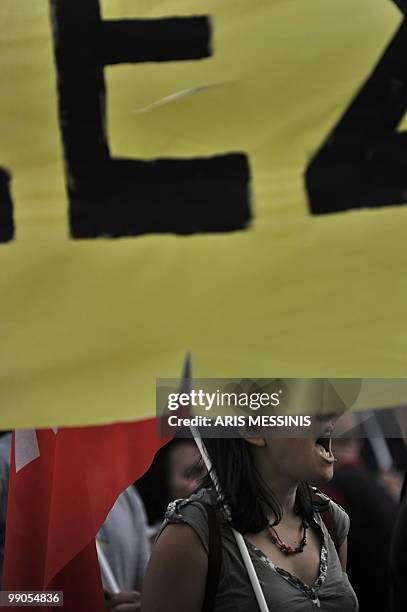 Woman sit shouts slogans during a demonstration against government's austerity measures in central Athens on May 12, 2010. Greece was to receive a...