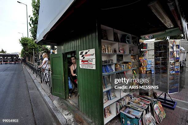 Kiosk owner looks on during a demonstration against government's austerity measures in central Athens on May 12, 2010. Greece was to receive a first...