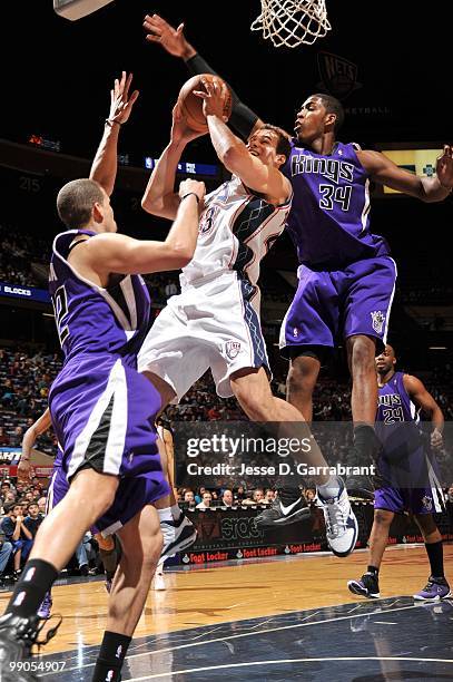 Kris Humphries of the New Jersey Nets puts a shot up against Jason Thompson of the Sacramento Kings during the game at the IZOD Center on March 24,...