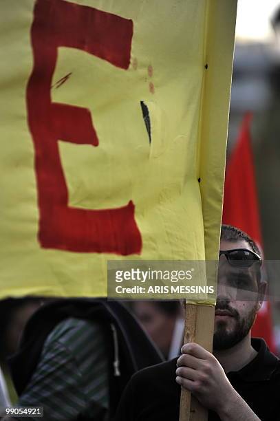 Demonstrator holds a banner during a protest against government's austerity measures in central Athens on May 12, 2010. Greece was to receive a first...
