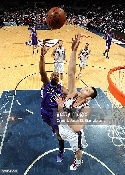 Carl Landry the Sacramento Kings puts a shot up against Yi Jianlian of the New Jersey Nets during the game at the IZOD Center on March 24, 2010 in...