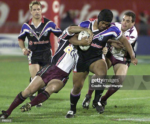 Iafeta Paleaaesina of the Warriors makes his debut and is tackled by Albert Torrens and Ben Walker of the Eagles during the round 15 NRL match...