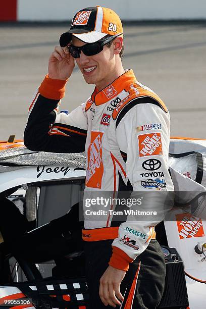 Joey Logano, driver of the Home Depot Toyota, stands on the grid during qualifying for the NASCAR Sprint Cup Series SHOWTIME Southern 500 at...