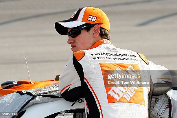 Joey Logano, driver of the Home Depot Toyota, stands on the grid during qualifying for the NASCAR Sprint Cup Series SHOWTIME Southern 500 at...