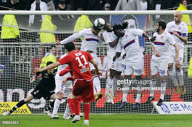 Lyon's players jump to hit the ball during the French L1 football match Lyon versus Monaco on May 12, 2010 at the Gerland stadium in Lyon. AFP PHOTO...