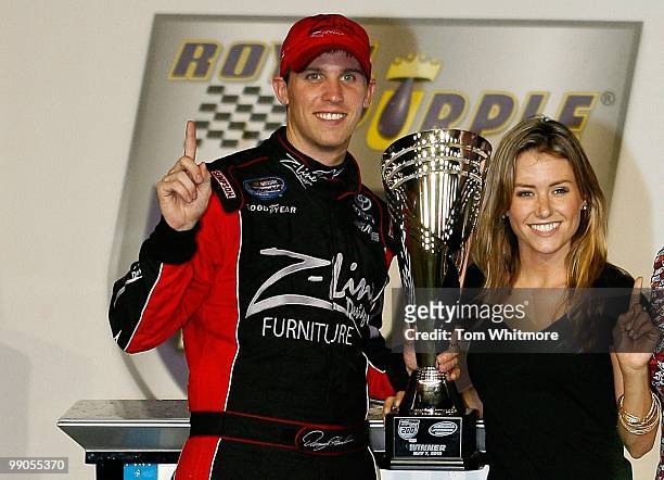 Denny Hamlin, driver of the Z-Line Designs / Operations Helmet Toyota, celebrates with his girlfriend Jordan Fish in victoory lane after Hamlin won...