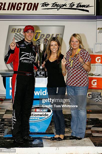 Denny Hamlin, driver of the Z-Line Designs / Operations Helmet Toyota, celebrates with his girlfriend Jordan Fish and mother Mary Lou in victoory...