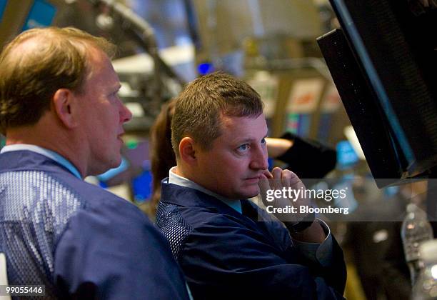 Traders work on the floor of the New York Stock Exchange in New York, U.S., on Wednesday, May 12, 2010. Stocks rose, with the Standard & Poor's 500...