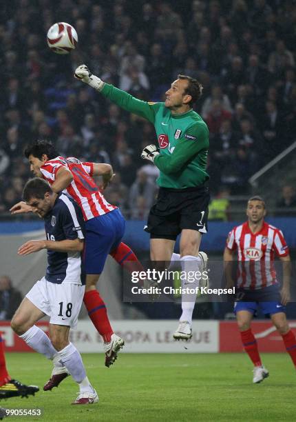 Goalkeeper Mark Schwarzer of Fulham battles for the ball with Sergio Aguero of Atletico Madrid during the UEFA Europa League final match between...