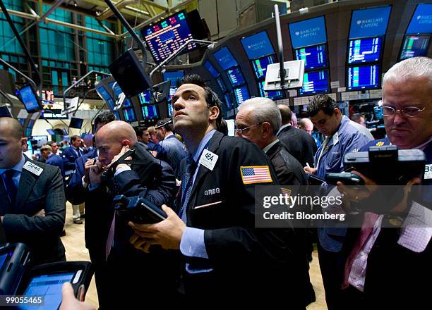 Traders work on the floor of the New York Stock Exchange in New York, U.S., on Wednesday, May 12, 2010. Stocks rose, with the Standard & Poor's 500...