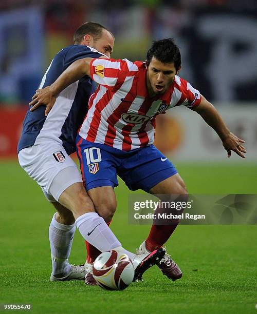 Sergio Aguero of Atletico Madrid is challenged by Danny Murphy of Fulham during the UEFA Europa League final match between Atletico Madrid and Fulham...