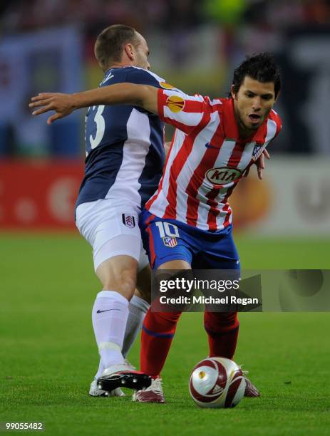 Sergio Aguero of Atletico Madrid is challenged by Danny Murphy of Fulham during the UEFA Europa League final match between Atletico Madrid and Fulham...