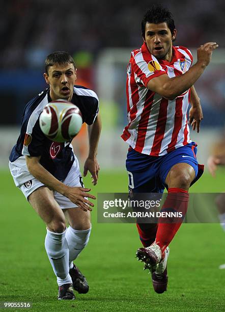 Fulham's Northern Irish defender Chris Baird and Atletico Madrid's Argentinian forward Sergio Aguero vie for the ball during the final football match...