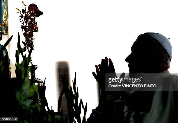 Pope Benedict XVI prays in front of the Madonna di Fatima statue in Fatima, on May 12, 2010. Pope Benedict XVI urged priests Wednesday to take a...