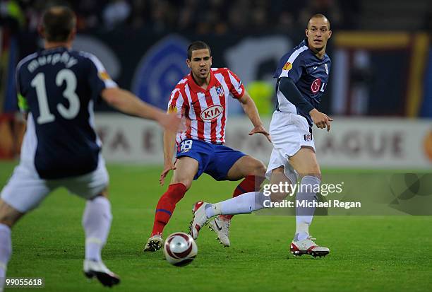 Alvaro Dominguez of Atletico Madrid and Bobby Zamora of Fulham follow the ball during the UEFA Europa League final match between Atletico Madrid and...