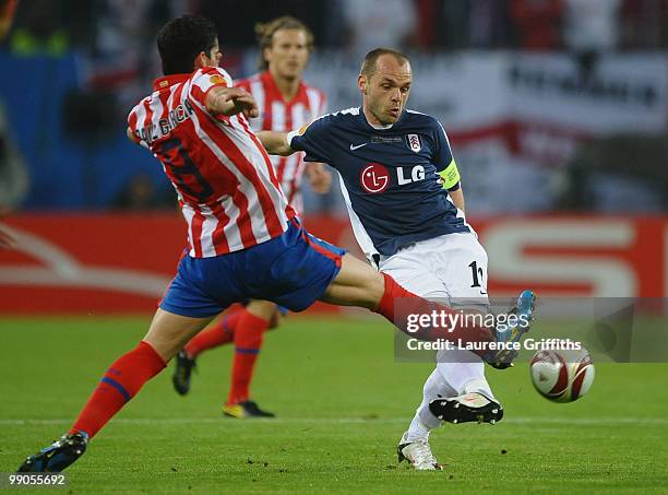 Danny Murphy of Fulham is challenged by Raul Garcia of Atletico Madrid during the UEFA Europa League final match between Atletico Madrid and Fulham...