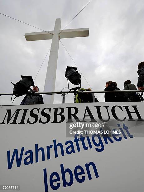 Banner reading "Abuse - live truthfulness" can be seen in front of a giant cross at the second Oecumenic Church Congress on May 12, 2010 in Munich,...