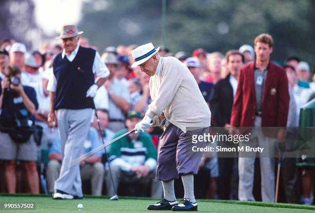Gene Sarazen tees off as Sam Snead looks on at the start of The Masters Tournament on April 11, 1999 in Augusta, Georgia. .