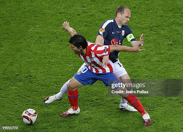Danny Murphy of Fulham is challenged by Sergio Aguero of Atletico Madrid during the UEFA Europa League final match between Atletico Madrid and Fulham...