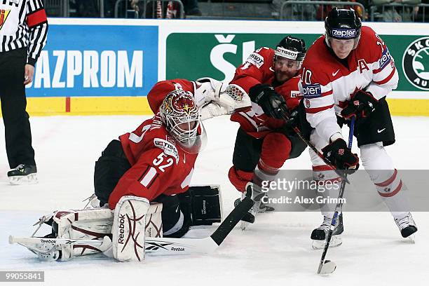 Corey Perry of Canada tries to score against Julien Vauclair and goalkeeper Tobias Stephan of Switzerland during the IIHF World Championship group C...