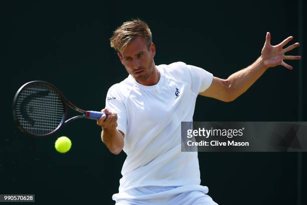 Peter Gojowczyk of Germany returns against Juan Martin Del Potro of Argentina on day two of the Wimbledon Lawn Tennis Championships at All England...