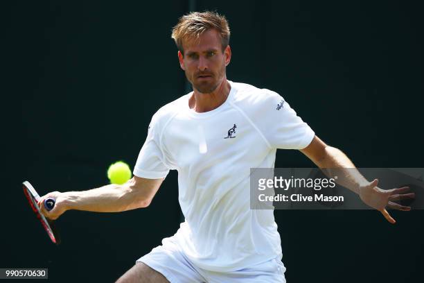 Peter Gojowczyk of Germany returns against Juan Martin Del Potro of Argentina on day two of the Wimbledon Lawn Tennis Championships at All England...