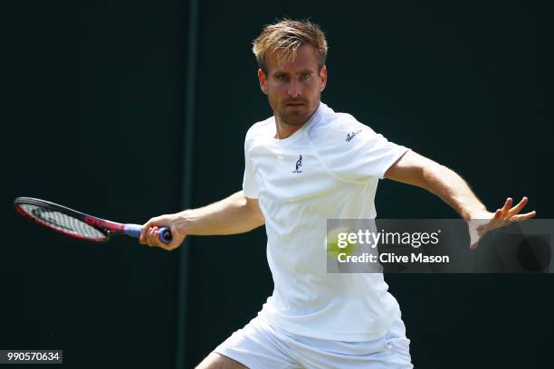 Peter Gojowczyk of Germany returns against Juan Martin Del Potro of Argentina on day two of the Wimbledon Lawn Tennis Championships at All England...