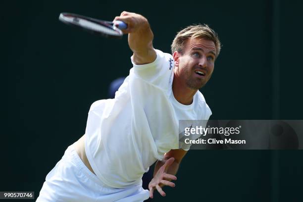 Peter Gojowczyk of Germany serves against Juan Martin Del Potro of Argentina on day two of the Wimbledon Lawn Tennis Championships at All England...
